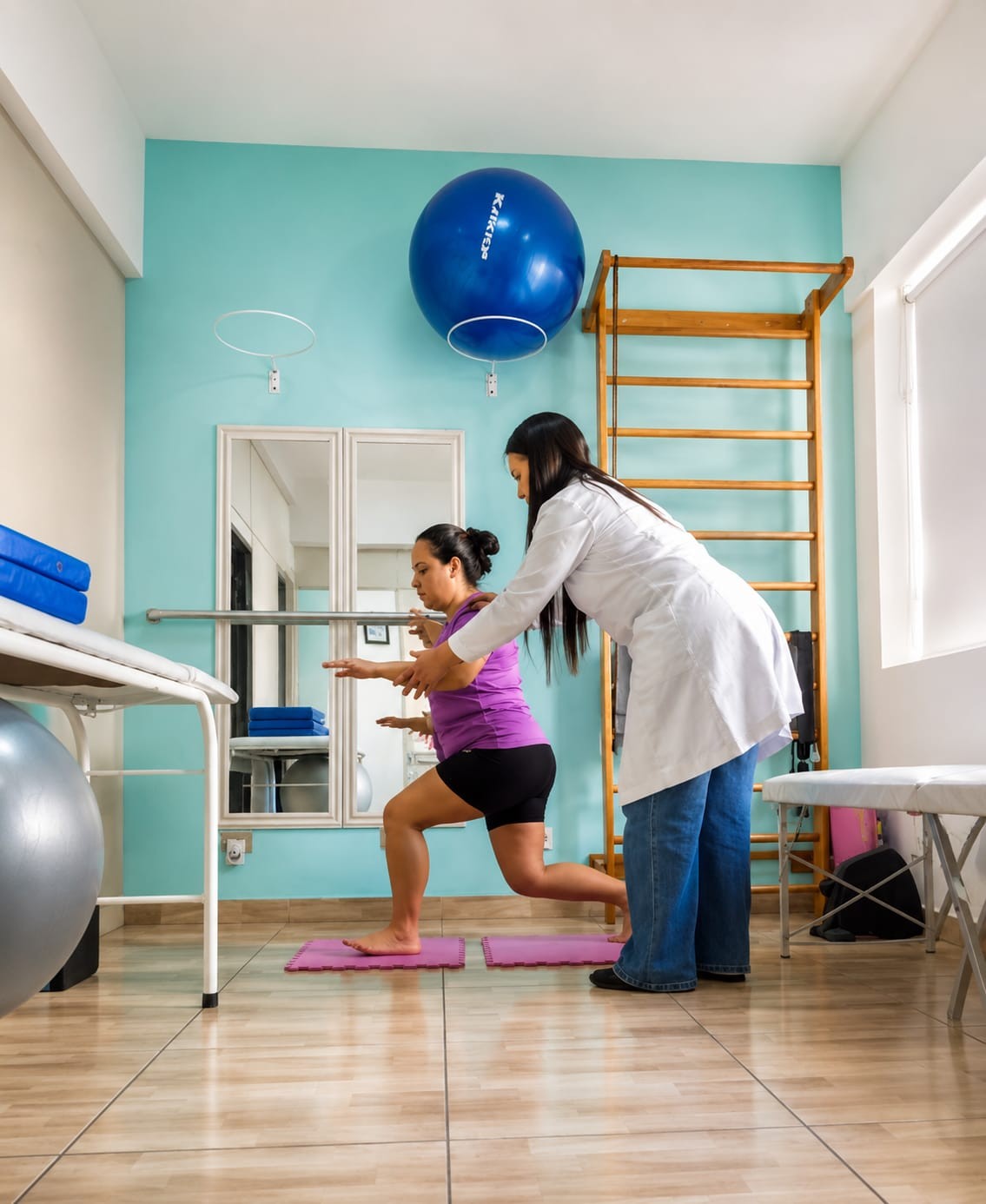 Fisioterapeuta acompanhando paciente durante exercício de fortalecimento na sala de tratamento